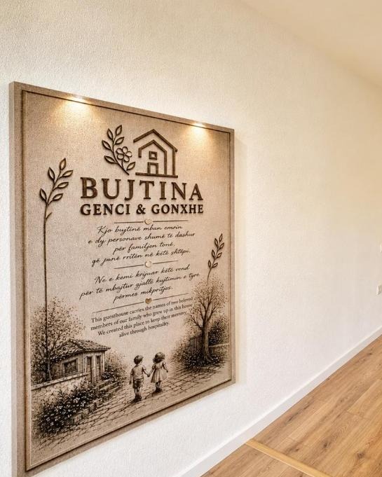 The framed family story of Bujtina Genci & Gonxhe, mounted in the home — “This guesthouse carries the names of two beloved members of our family who grew up in this home.”